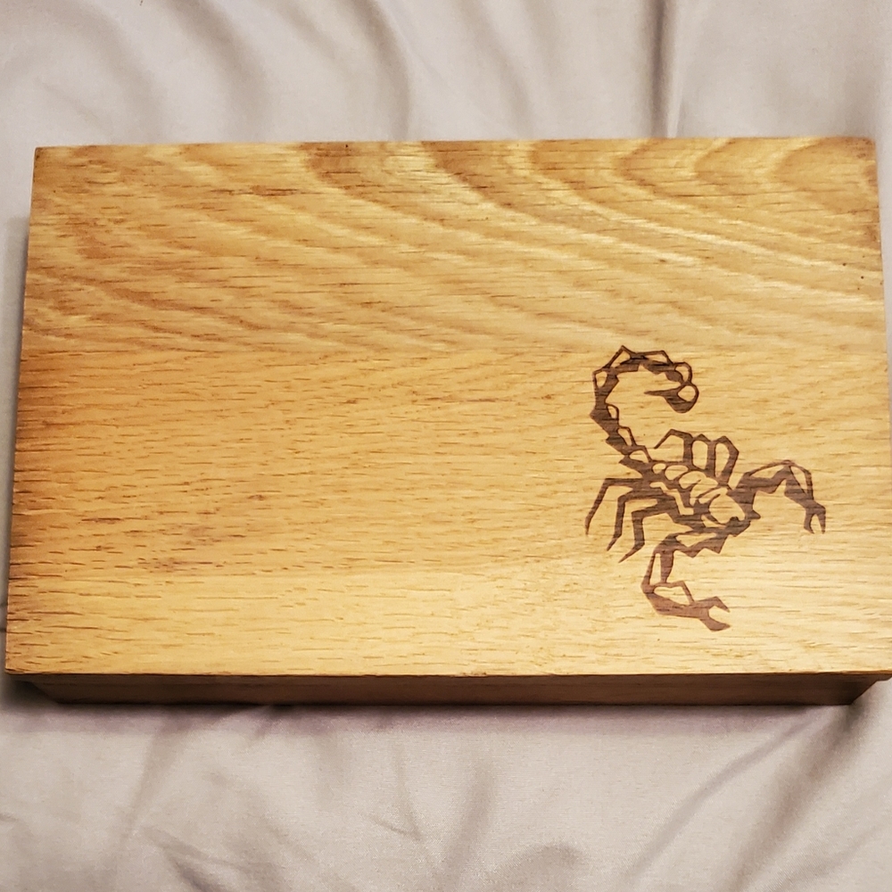 Handmade wooden box with scorpion imprint on it.
